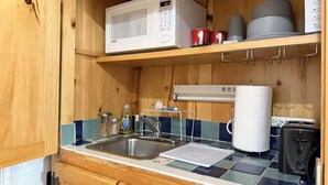 A compact kitchen with a microwave, sink, and a toaster. - Amira Resort #17 | Studio | Near Pool & Pickleball (Saint George)
