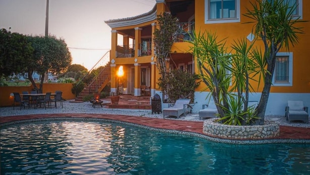 A two-story building with a swimming pool, outdoor seating, and a staircase leading to the upper floor. - Chalet With Pool Meia Praia Beach, Lagos (Lagos)