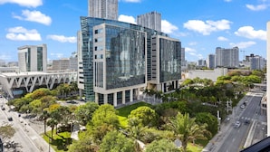 A modern building with a glass facade, surrounded by greenery and a clear blue sky. - Skyline Pool & Spa Miami (Miami)