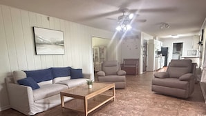 A living room with a sofa, armchairs, a coffee table, and a painting on the wall. - Peaceful country home minutes from Lake Mitchell (Clanton)