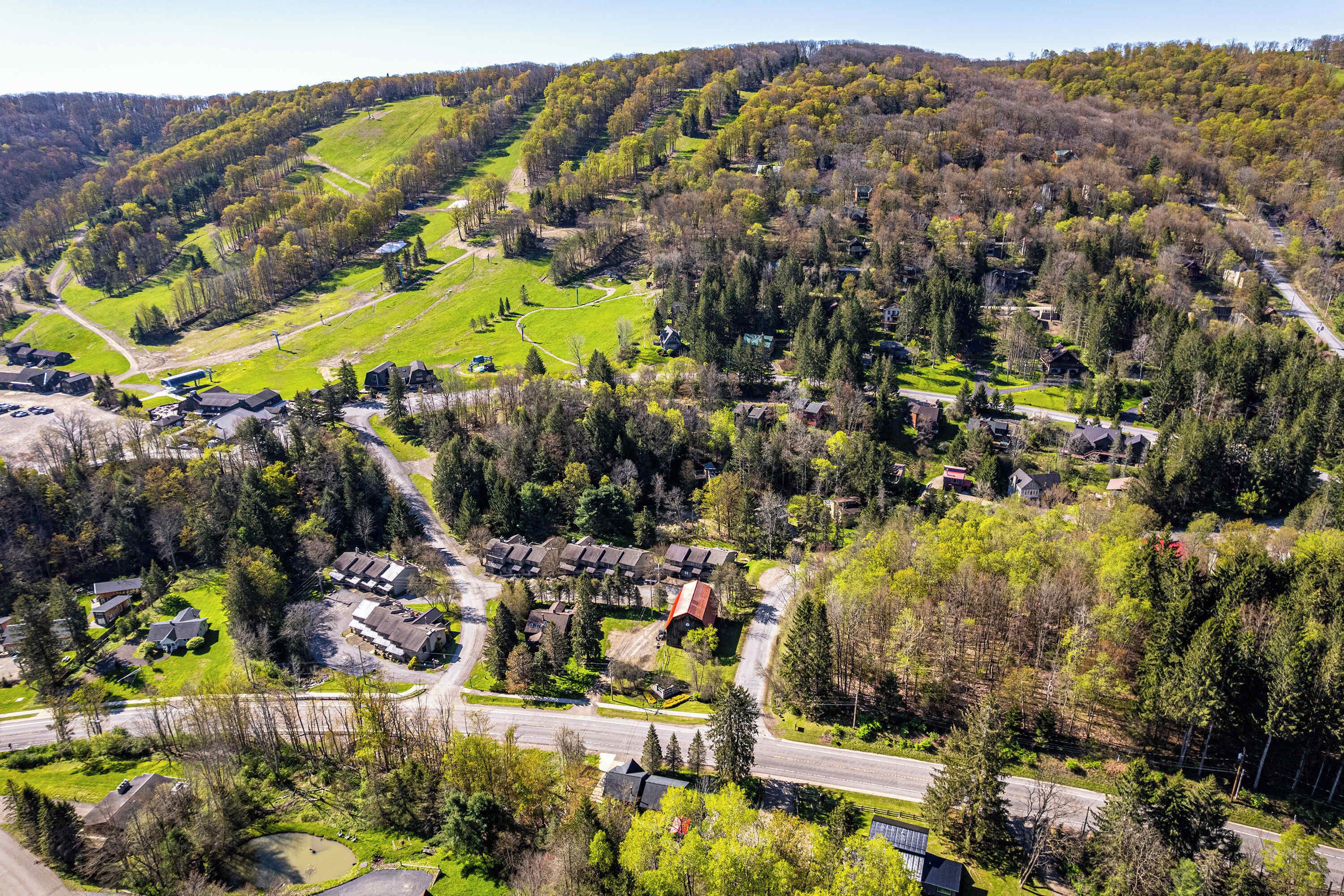A residential area with houses, roads, and green spaces.