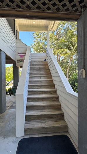 A wooden staircase leading to an outdoor area with a pergola overhead. - NEW Rental ~ Fish, Boat & Relax in Cudjoe Key with Ocean Access (Cudjoe Key)
