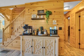 A wooden interior with a staircase, a coffee bar, and a floor heat thermostat. - Cliffside Cabin, Stunning views and 100% privacy (West Decatur)