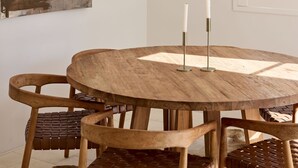 A round wooden table with four chairs, each with a woven seat. - Casa Bianca, Bondi IH (Bondi)