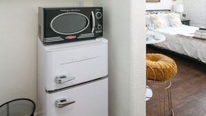 Una cuineta compacta amb microones, torradora i cafetera.