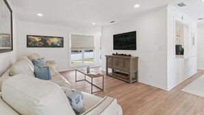 Ein modernes Wohnzimmer mit einer Couch, einem Couchtisch und einem Schrank.