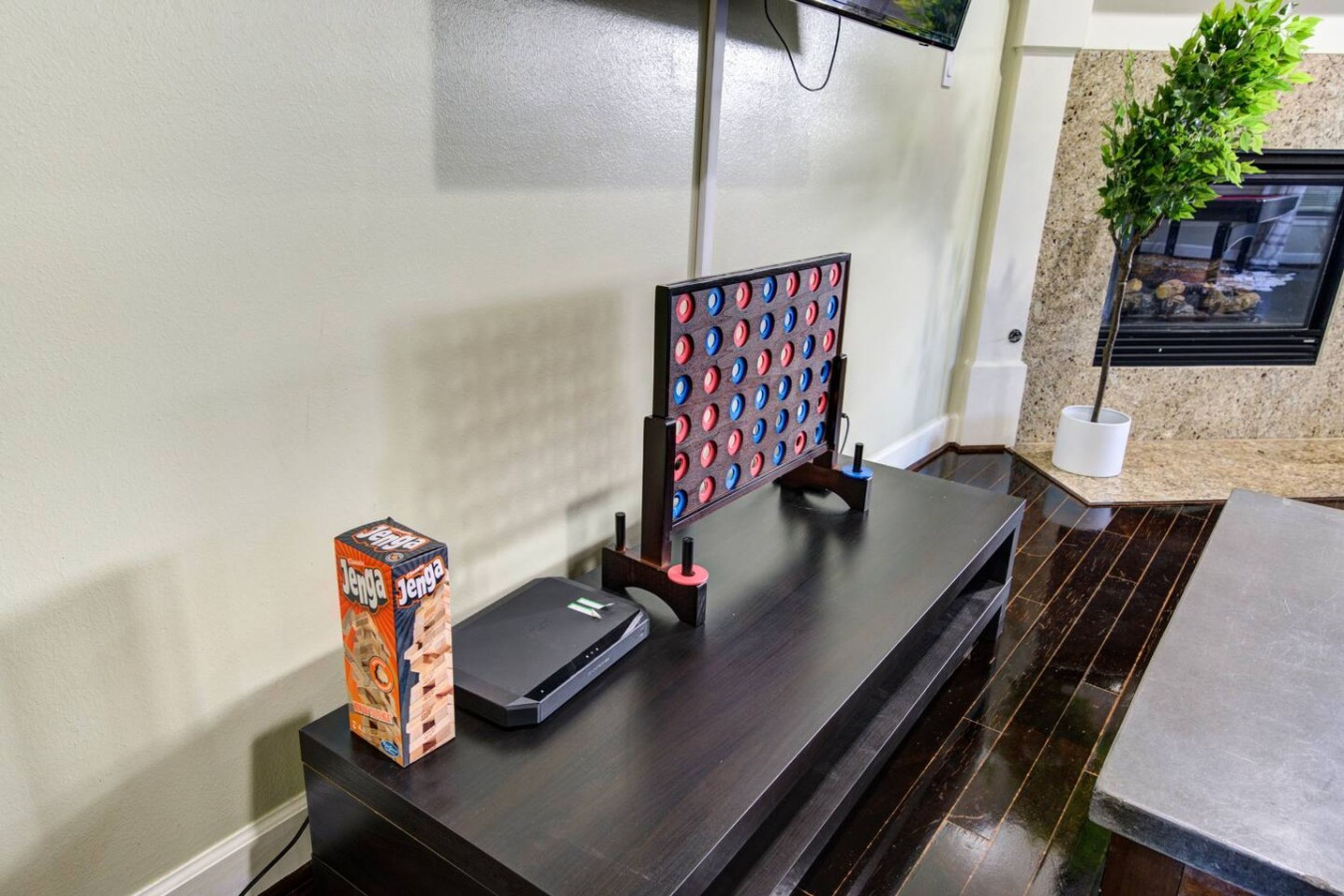 A desk with a Jenga box, a Jenga game, and a Jenga stand.