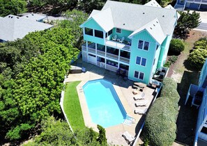 A two-story building with a pool, outdoor seating, and a balcony. - Oceanside, Priv Pool, Hot Tub, Rec Rm-DL102, Aqua Duck (Duck)