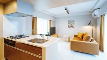 Premier Family One-Bedroom Apartment | Living area | 50-inch Smart TV with satellite channels
