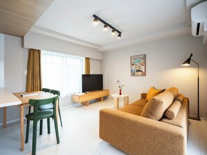 Premier Family One-Bedroom Apartment | Living area | 50-inch Smart TV with satellite channels