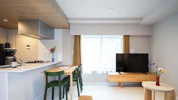 Premier One-Bedroom Apartment - Ground Floor | Living area | 50-inch Smart TV with satellite channels