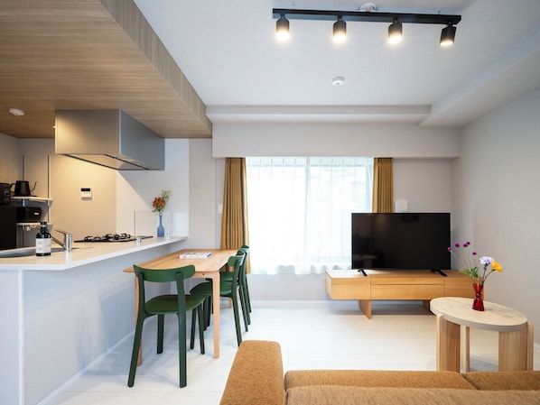 Premier Family One-Bedroom Apartment | Living area | 50-inch Smart TV with satellite channels