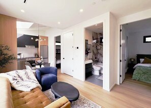 A modern apartment with a living area, kitchenette, and a bathroom. - New Build 3 Brms Kitslano Retreat (air-conditioned) (Vancouver)