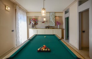A pool table with balls, a decorative light fixture, and a painting on the wall. - Pet friendly home in Galleno (Galleno)
