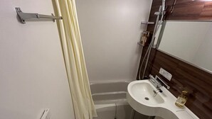A small bathroom with a toilet, sink, and shower. - Smile Hotel Kanonji (Kanonji)