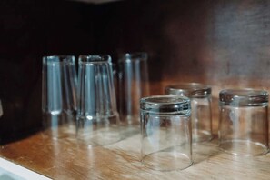 A row of clear glass bottles on a wooden surface. - Oceanview Studio w/Balcony • Ocean Breezes + A/C (Carolina)