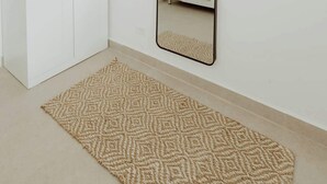 A room with a wardrobe, a mirror, and a patterned rug. - Elegant Studio with Ocean Views - Isla Verde Beach (Carolina)