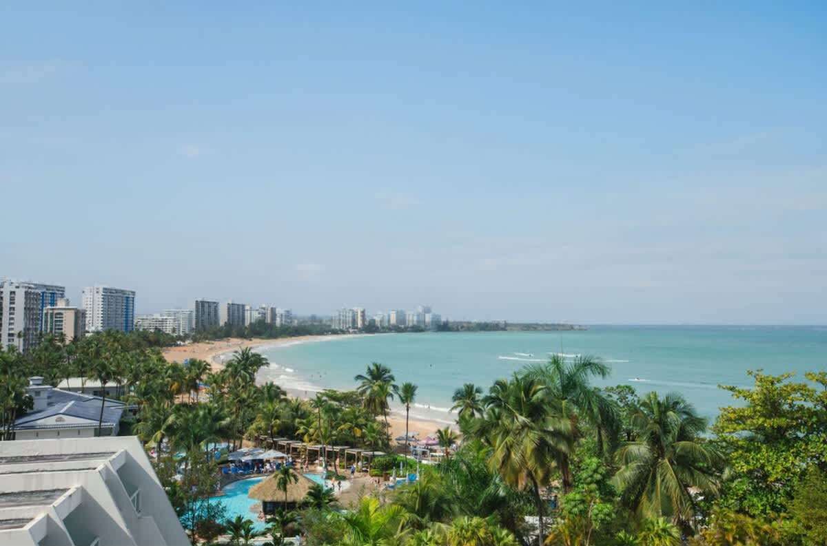 A resort with a pool, beach, and ocean view.