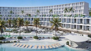 A modern hotel with multiple balconies, a pool area, and outdoor seating. - Oikos Maragogi Resort - GAV Resorts (Maragogi)