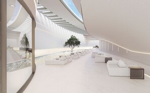 A modern interior with a curved ceiling, seating areas, and a central tree. - Oikos Maragogi Resort - GAV Resorts (Maragogi)
