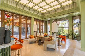 A spacious lobby with a high ceiling, large windows, and a reception desk. - Bright 2-bedroom apartment in center of Bangtao (Tambon Choeng Thale)