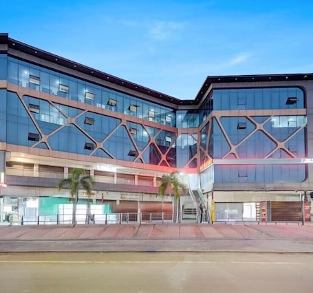 A multi-story building with a modern architectural design, featuring a glass facade and geometric patterns.. Hotel Lakeview Vadodara