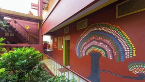 A building with a staircase and a colorful mural on the wall. - Ganpati Guest House (Varanasi)