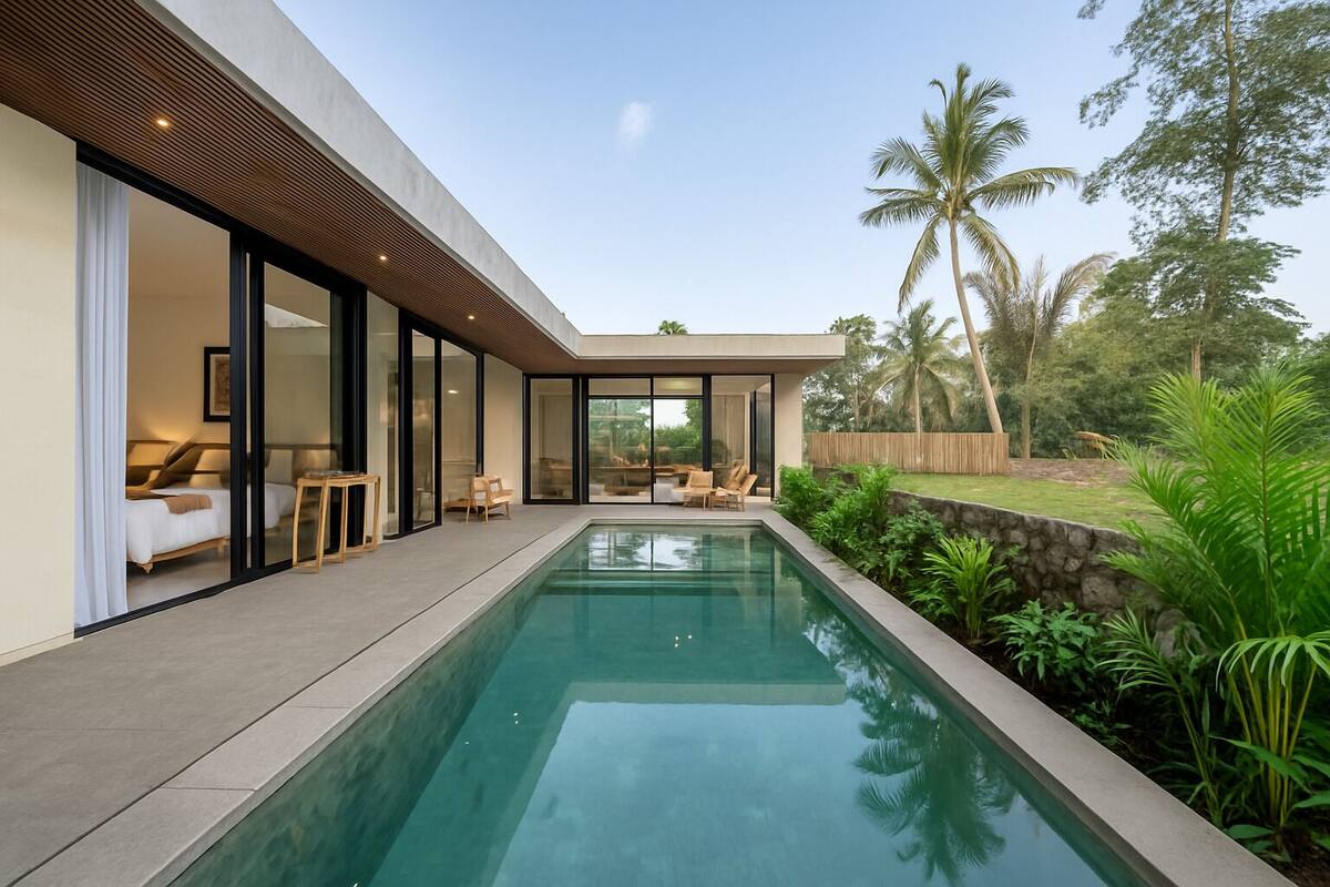 A modern house with a swimming pool, large glass doors, and a view of palm trees.