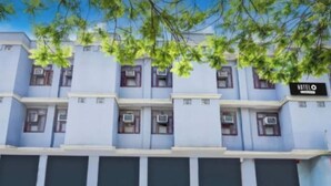 A hotel facade with multiple windows, air conditioning units, and a sign indicating the hotel name. - Hotel GSA and BANQUET (Haridwar)