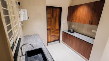 Family Triple Room | Private kitchen | Electric kettle, dining tables