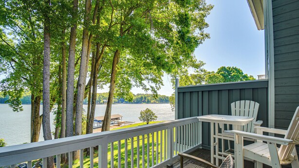 A deck with a white railing, a table, and two chairs overlooking a lake. - Swim Dock Access! Moneta Escape, 5 Mi to Boat Ramp (Moneta)