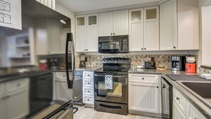 A modern kitchen with stainless steel appliances, white cabinetry, and a tiled backsplash. - Swim Dock Access! Moneta Escape, 5 Mi to Boat Ramp (Moneta)