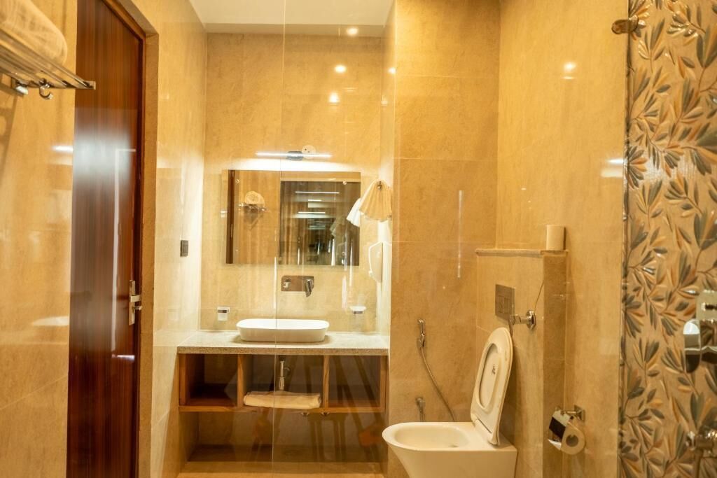 A bathroom with a sink, toilet, and shower.