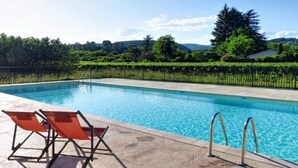 A swimming pool with two lounge chairs and a metal ladder. - Mezzanine Cottage for 6 in Ardèche (Chambonas)