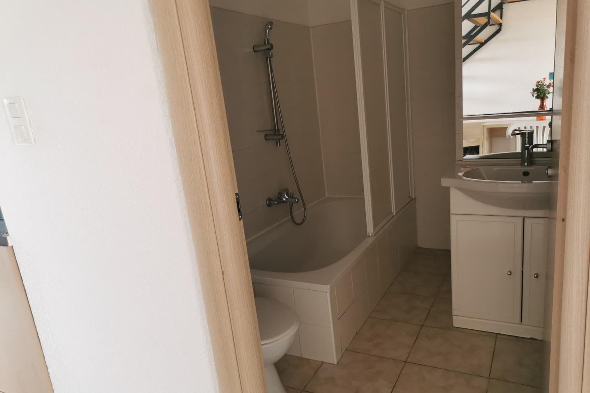 A bathroom with a bathtub, toilet, and sink.