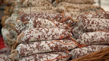 A stack of sausages tied with orange string.