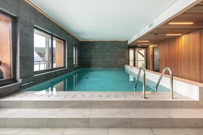 An indoor swimming pool with a clear view of the surrounding walls, a wooden panel design on one side, and a tiled floor. - 2-Person Studio near Ski Lifts (VAUJANY (ISERE))