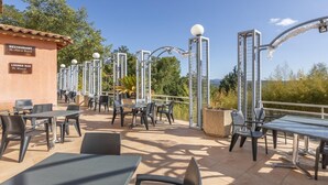 An outdoor patio area with tables and chairs, a restaurant sign, and exercise equipment. - Apartment for 4 with Private Terrace (CALLIAN (VAR))