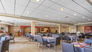 A spacious dining area with multiple tables and chairs, a kitchen in the background, and a ceiling with recessed lighting. - Apartment for 4 with Private Terrace (CALLIAN (VAR))