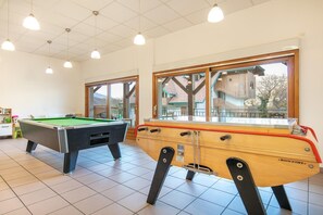 A pool hall with two pool tables, wooden cabinets, and large windows. - Studio for 2 near Lake Annecy (GIEZ LAC ANNECY (HAUTE-SAVOIE))