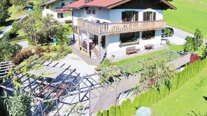 A chalet-style building with a balcony, surrounded by lush greenery and mountains. - Chalet Near Skilift & Bikepark in Leogang (Leogang)