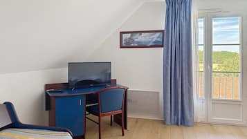 Ein Zimmer mit Schreibtisch, Stuhl und Bett.