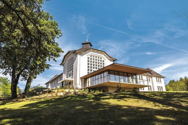 A large, white building with a prominent central tower, extensive windows, and a sloped roof. - Spa Retreat in La Roche-Posay (La Roche-Posay)