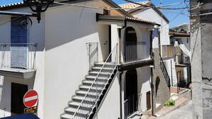 Un bâtiment avec un escalier, un panneau indiquant « accès interdit » et un lampadaire.