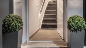 A modern hotel entrance with a staircase leading to the interior. - Chrison modern house (Zakynthos)