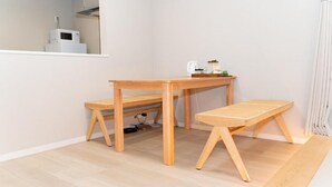 A room with a wooden desk and bench, a white wall, and a window. - Dc Sakura Hotel-HitomiHouse (Osaka)