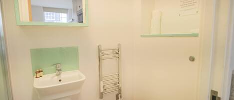 A bathroom with a sink, mirror, and toilet.