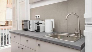 A modern kitchen with a built-in sink, a toaster, and a coffee maker. - Charming Couples' Apartment in Zakynthos Town (Zakinthos)