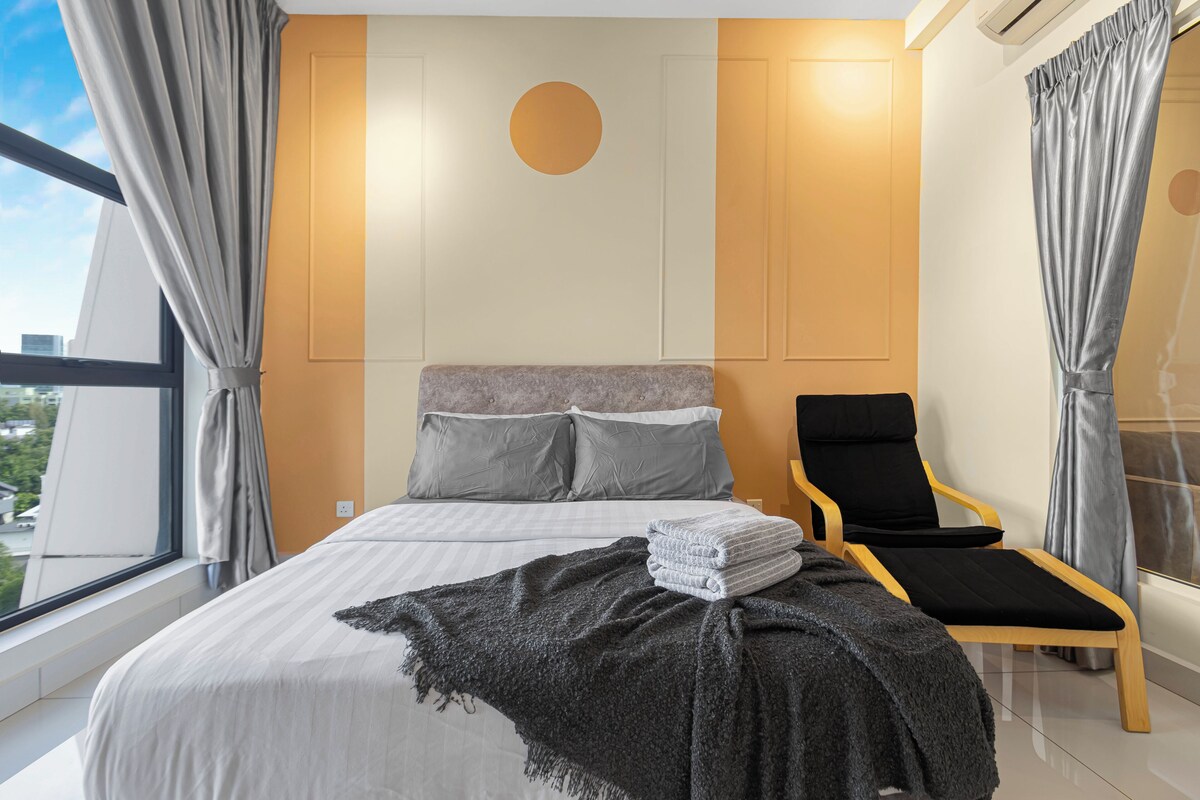 A modern bedroom with a bed, a chair, and a view of the city.