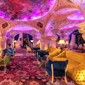An opulent room with ornate ceilings, plush seating, and a richly patterned carpet. - Arte Mont Kiara Bedstay (Kuala Lumpur)